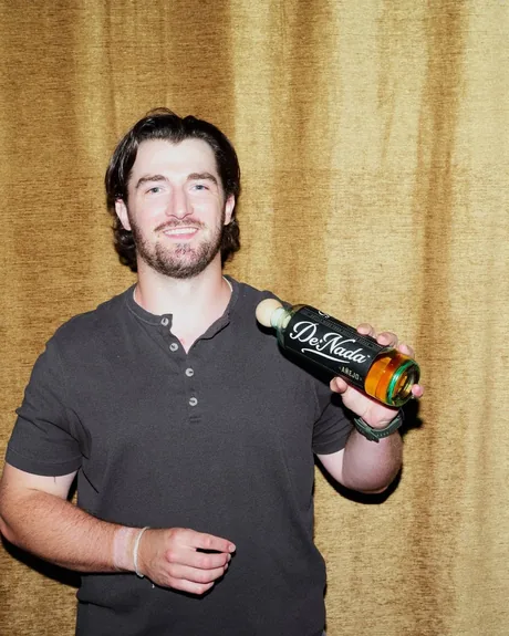 Danny with the bottle of De Nada A&ntilde;ejo