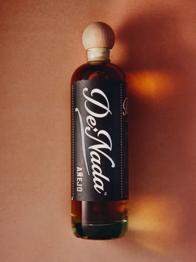 The Añejo lying on terracotta in a shaft of late light