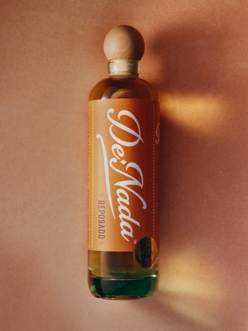 The Reposado lying on terracotta, the gold medal on the label catching the light